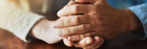 Hands clasped caring image